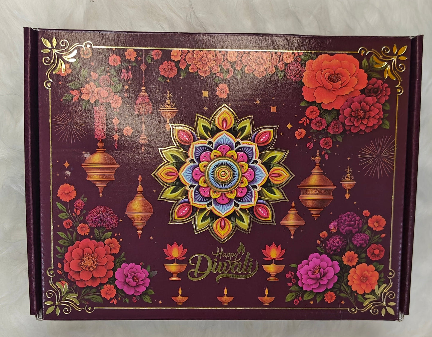 Decorative box with floral and mandala design on a white fur background